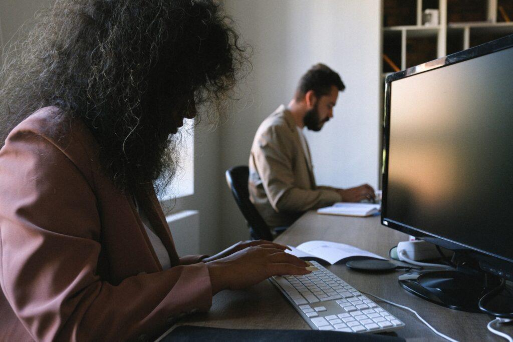 People sitting in a desk working on an office