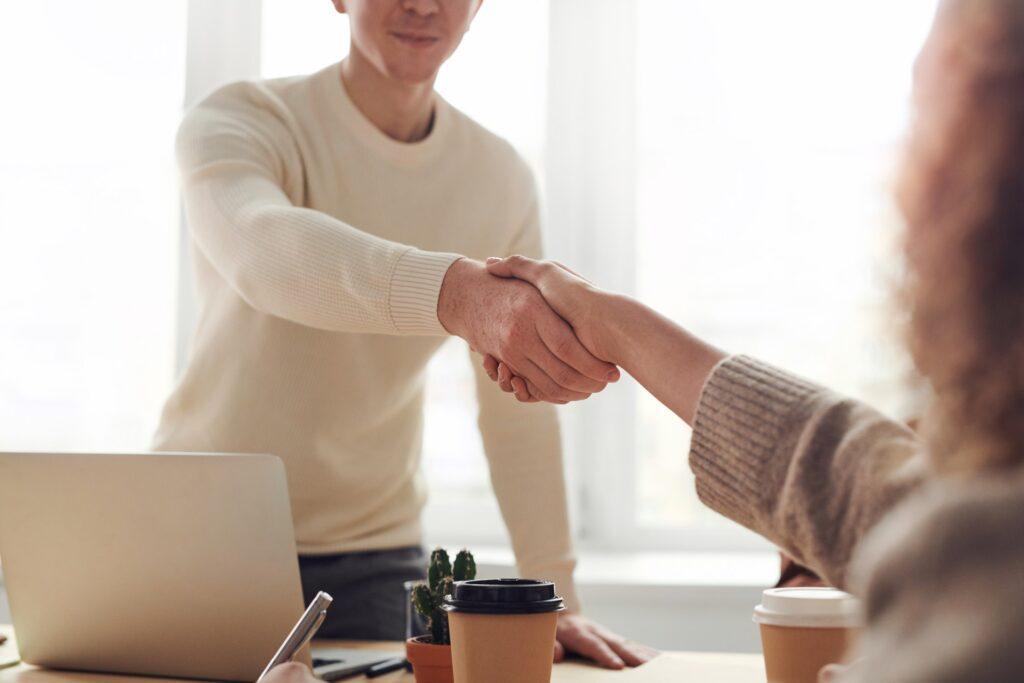 Man shaking hands with a woman