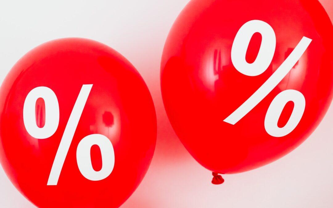 two red balloons with percentage symbols on white background