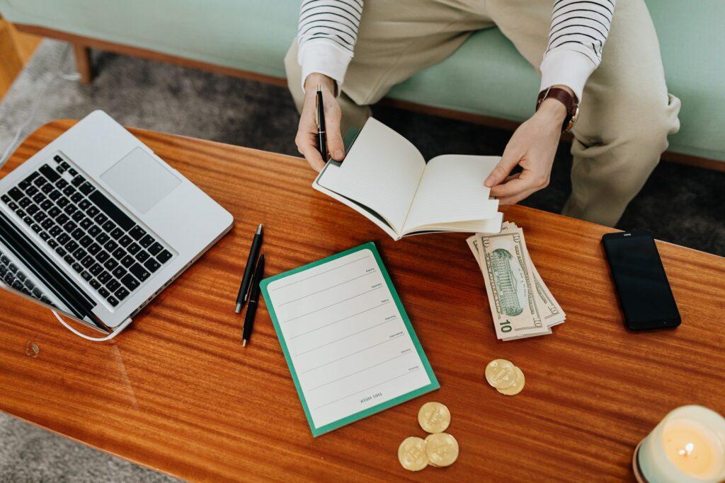 person sitting on the couch while holding a notebook